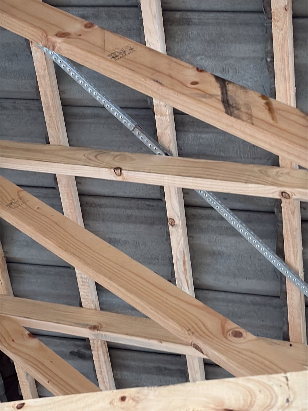 Improper roof metal bracing splicing, recorded during a frame inspection in Sunbury