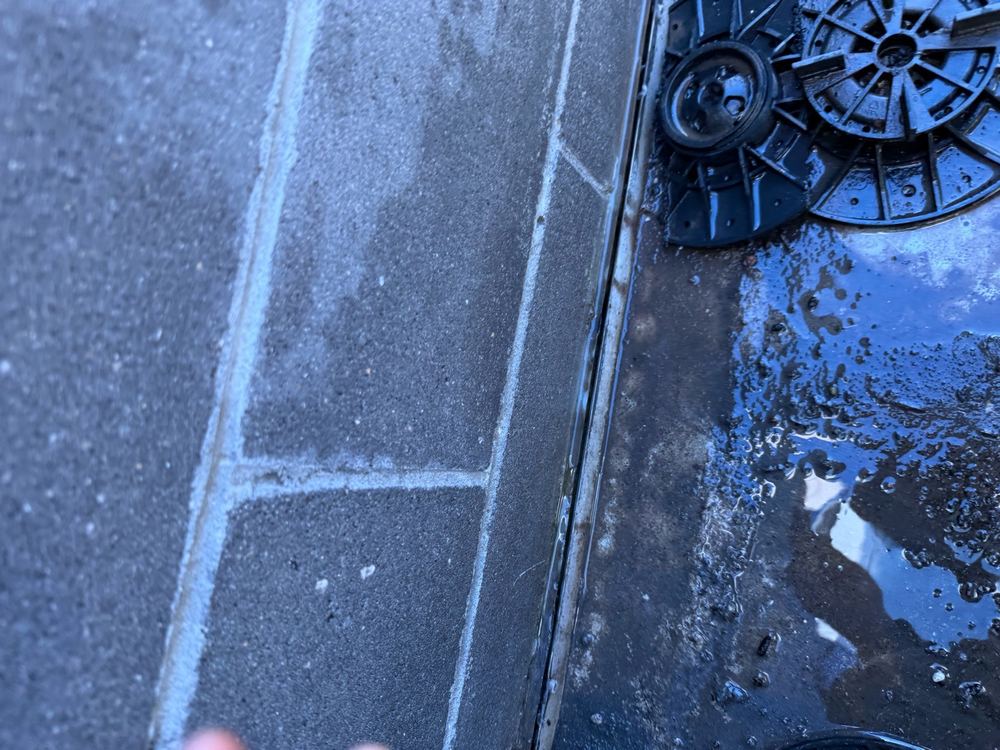 Face-fixed balcony flashing where rain runs down the wall above, found during a defect investigation in Bundoora