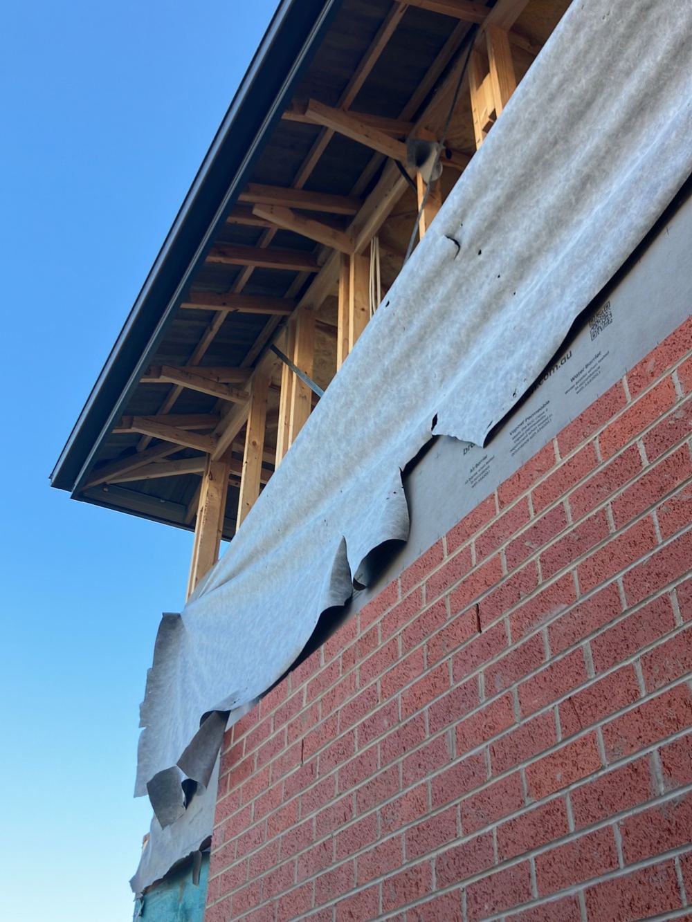 Wall wrap torn in several places and needing taped repairs, found during a lock-up inspection in Sunbury