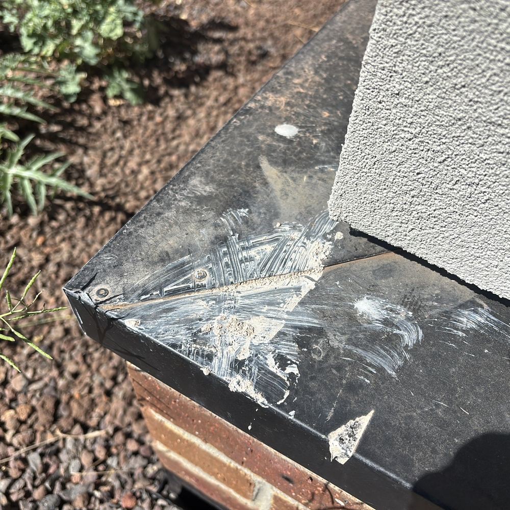 Degraded sealant on roof flashings, weakening the weatherproofing, found during a pre-handover inspection in Sunbury