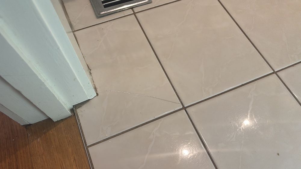 Cracked floor tile in a wet area, found during a pre-purchase inspection in Westmeadows
