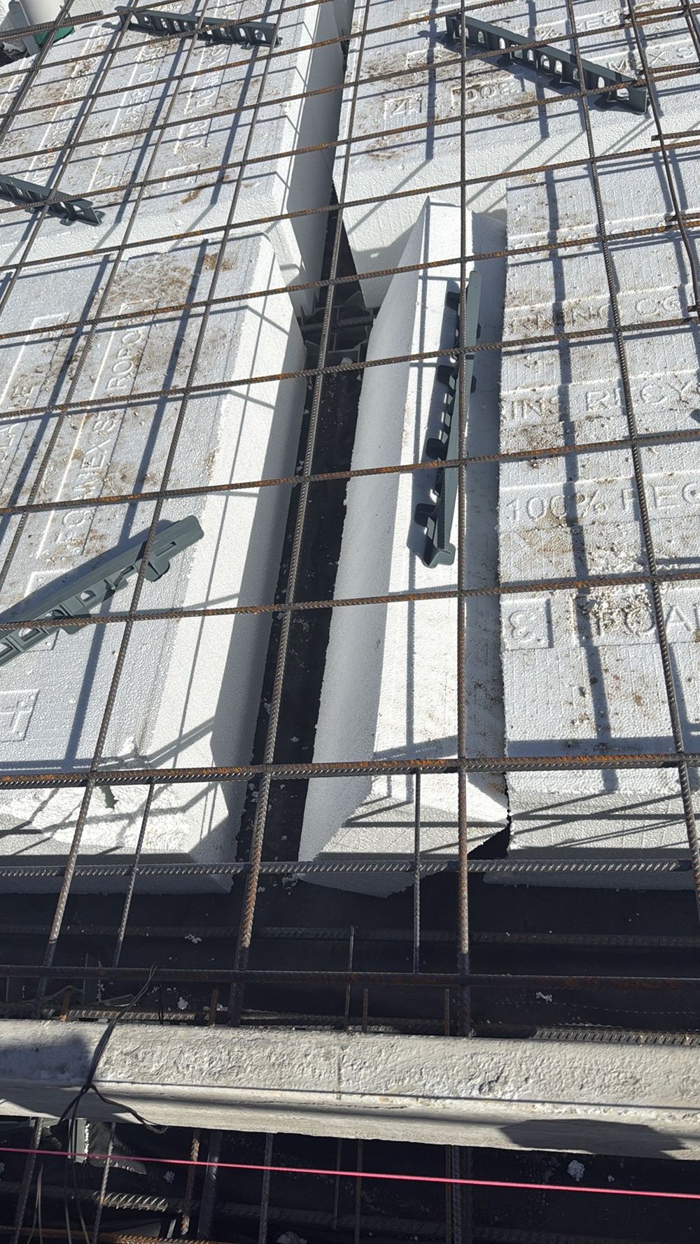Waffle pods left unfixed, free to drift and squeeze the beams narrower, found during a slab pre-pour inspection in Sunbury